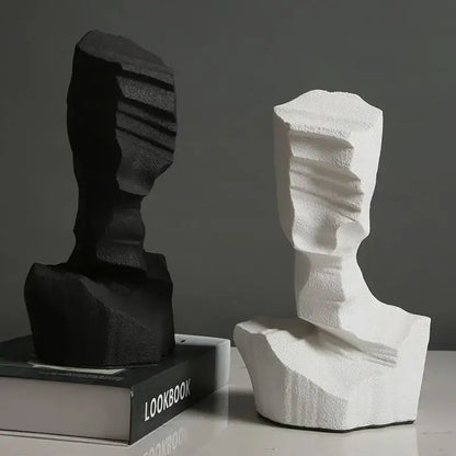Black and white abstract characters sculpture bookends with textured layered surfaces for modern living room decor by decorbites