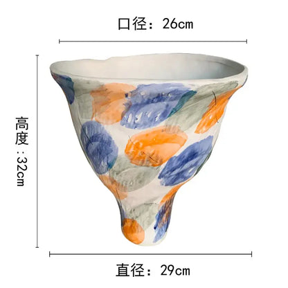 A hand-painted DecorBites abstract clay colorful ceramic pot with flared rim and tapered base for home decor