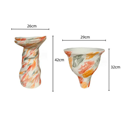 Two hand-painted decorbites abstract clay pots with colorful orange red and green brushstrokes on white ceramic vases
