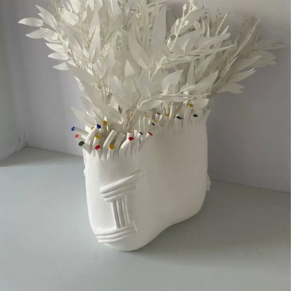 Decorbites abstract coral ceramic vase shaped like a white stylized human face with coral shapes flower decoration