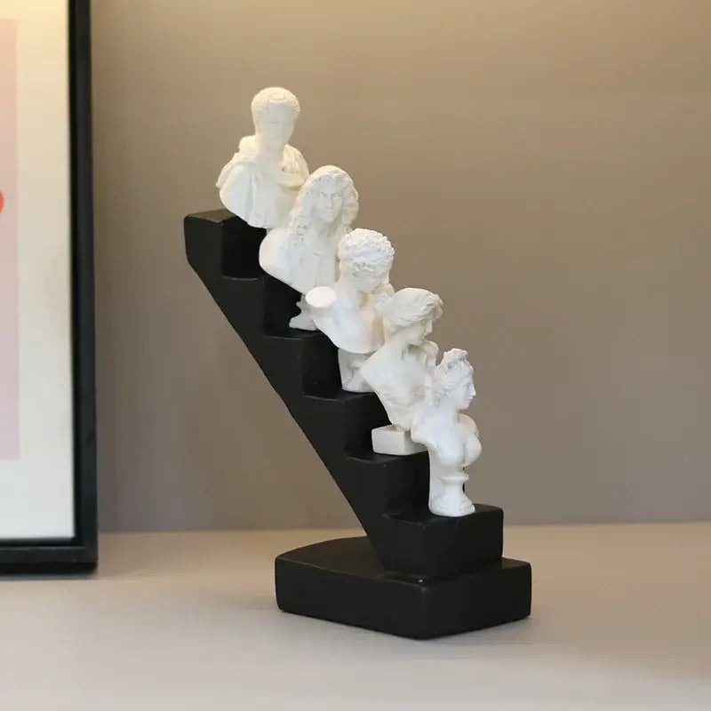 White resin DecorBites abstract David statue busts arranged in staircase design on black base for home decor