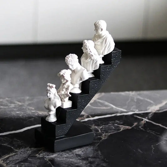 White marble busts of classical figures in a staircase design on a black base for decorbites abstract david home decor