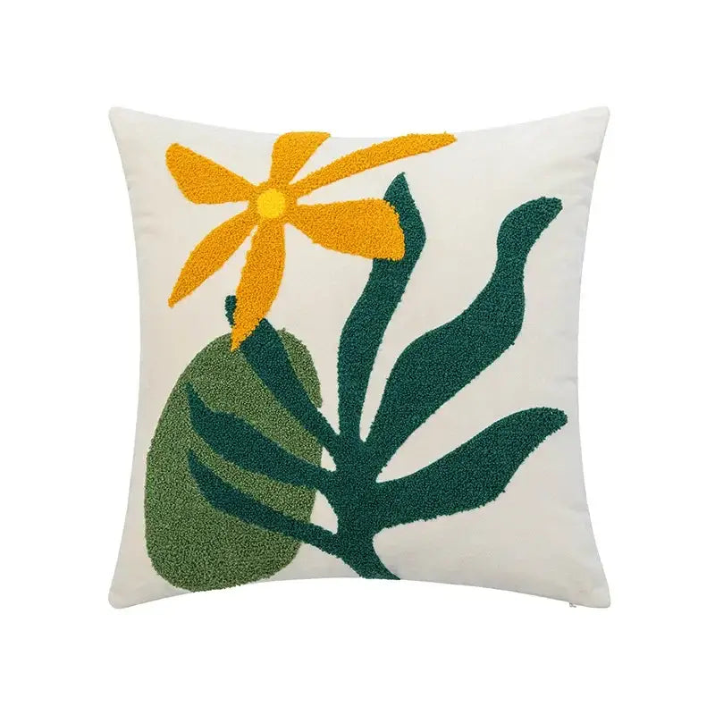 Cream-colored velvet cushion cover with vibrant orange-yellow flower and green leaves abstract embroidery by decorbites