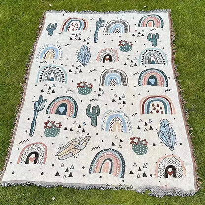 Decorbites abstract face pattern throw blanket in off-white woven fabric with colorful rainbows cacti and crystals
