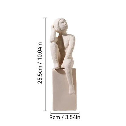 Minimalist white ceramic DecorBites abstract family character sculpture seated with hand on head on rectangular base