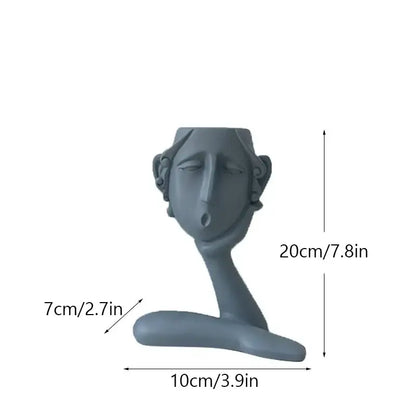Gray ceramic decorbites abstract family flowerpot ornament with stylized human face and serene expression for home decor