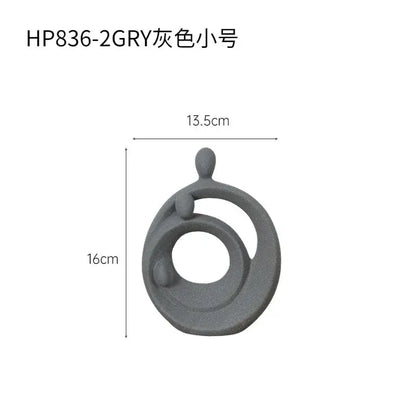 Gray ceramic decorbites abstract family sculpture set featuring an abstract family sculpture with circular and rounded elements
