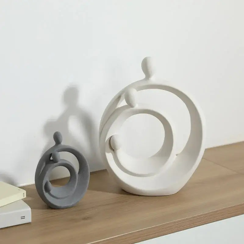 White ceramic decorbites abstract family sculpture set featuring flowing circular forms and minimalist figures