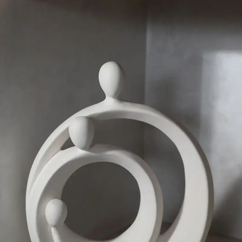 White ceramic decorbites abstract family sculpture set featuring interconnected circular and rounded egg like forms