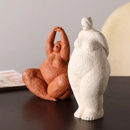 Two decorbites abstract fat lady figurines in terracotta and white resin depicting curvy women in relaxed poses