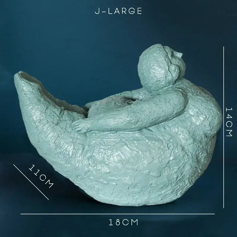 Light teal resin decorbites abstract fat lady figurine of a reclining vintage woman with arms wrapped around body