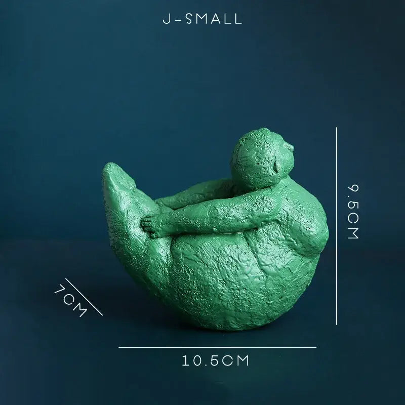 Green textured resin decorbites abstract fat lady figurine of a seated woman hugging her knees for home decor