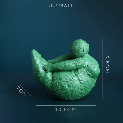 Green textured resin decorbites abstract fat lady figurine of a seated woman hugging her knees for home decor