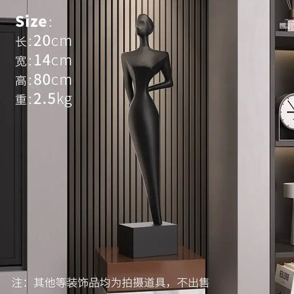 Black matte-finished decorbites abstract figure art sculpture of a female form on square base for luxury living decor