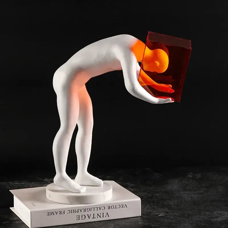 White resin abstract figure sculpture holding a glowing red cube representing cage human body mind decor figurine