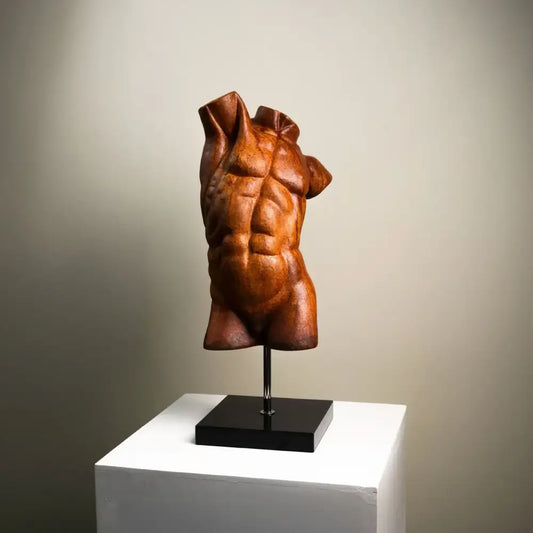 Bronze-colored muscular torso decorative figurine with detailed abs and draped fabric folds by decorbites abstract figure sculpture