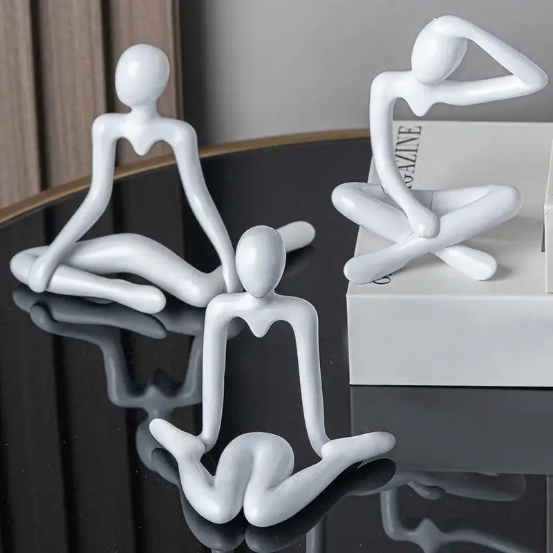 Three minimalist white ceramic decorbites abstract figures ornament sculpture depicting abstract human poses for home decor