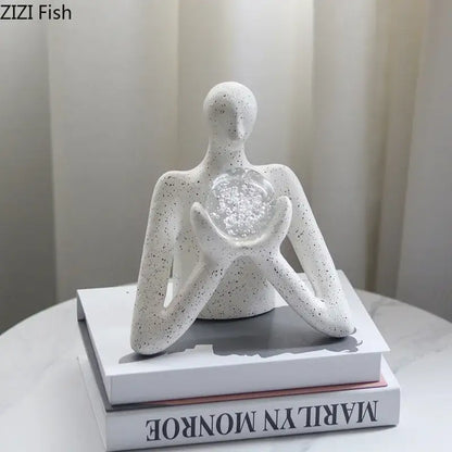 White speckled ceramic decorbites abstract figures sculpture holding clear glass orb for sculpture decor and room aesthetics