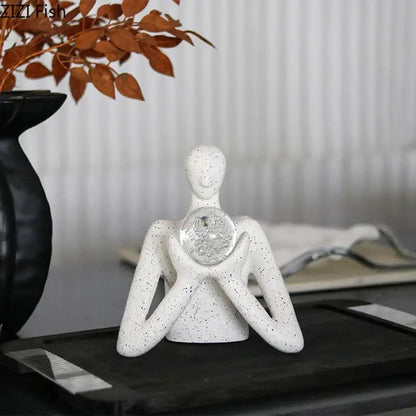 White speckled ceramic decorbites abstract figures sculpture decor cradling clear textured glass orb for room aesthetics