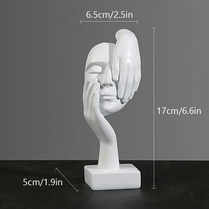 White resin decorbites abstract figurines sculpture showing a face with two hands cradling it on a square base