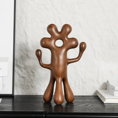 A smooth polished wooden decorbites abstract flower man sculpture with rounded limbs for home decor