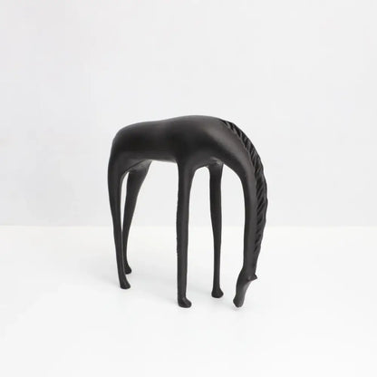 Black matte-finished decorbites abstract horse iron sculpture with elongated legs and textured mane for living room decor