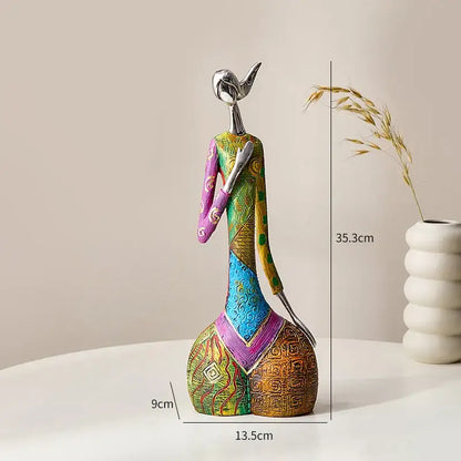 Decorbites abstract woman slender sculpture with metallic silver head and vibrant patterned fabric for living room decor