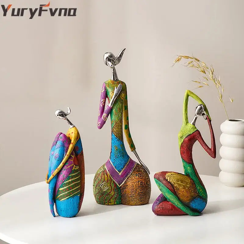 Decorbites abstract woman sculpture featuring vibrant patterned bodies and metallic heads for living room decor