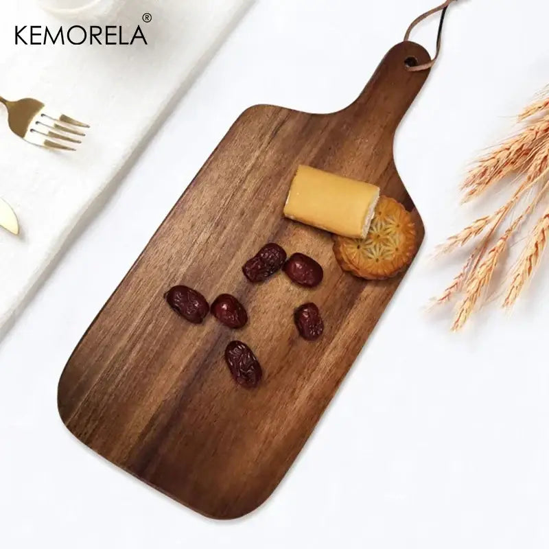 Dark brown acacia wooden chopping block with handle and leather tie for versatile kitchen use by decorbites