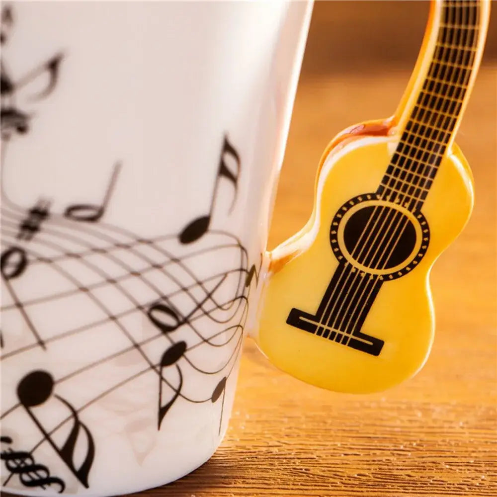 Yellow plastic acoustic guitar mug clip with black string and soundhole details for DecorBites ceramic coffee cup