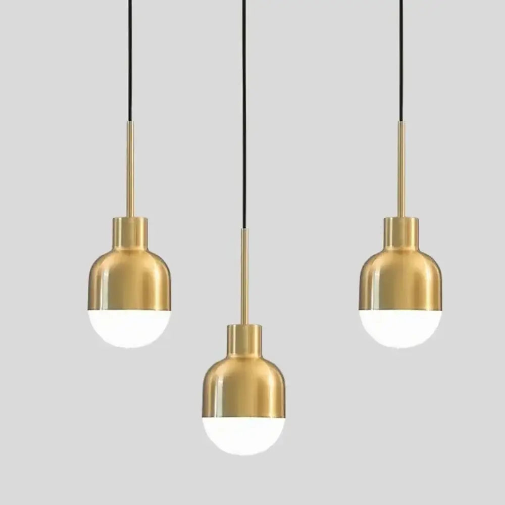 Three decorbites™ acrylic ball pendant lights with gold metal shades and soft white globe bulbs for modern ceiling decor