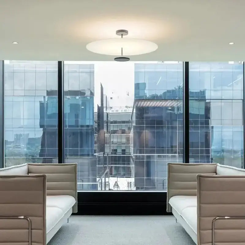 Modern minimalist acrylic black round chandelier with sleek circular white diffuser and metallic central fixture for bedroom lighting