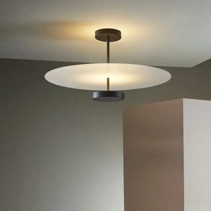 Modern minimalist acrylic black round chandelier with frosted white glass disc and dark bronze frame for bedroom lighting