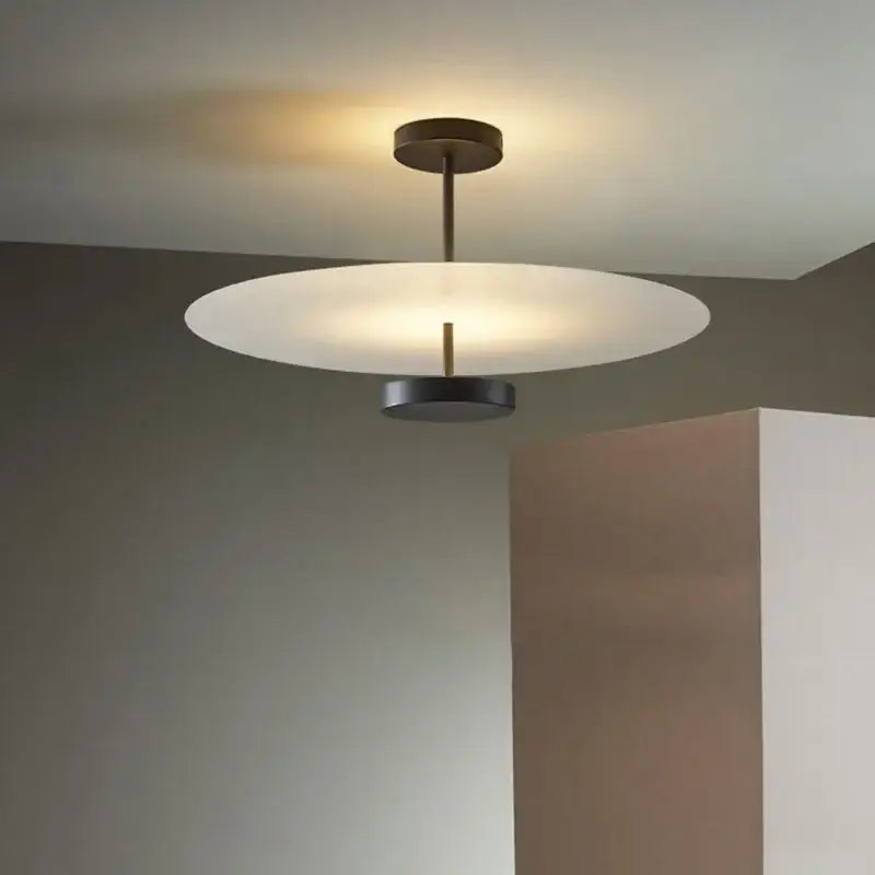 Modern minimalist acrylic black round chandelier with frosted white glass disc and dark bronze frame for bedroom lighting