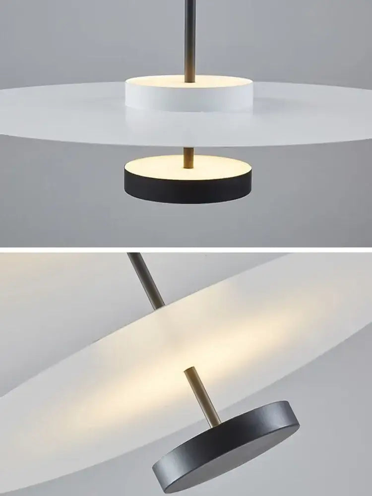 Modern minimalist acrylic black round chandelier with brass accents and frosted glass diffusers for bedroom and salon lighting