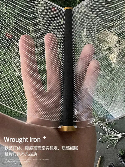 Transparent perforated mesh fan with black handle and gold end caps for DecorBites acrylic blade stair chandelier