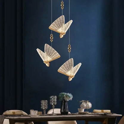 Three elegant gold-toned acrylic butterfly chandelier ceiling lamps with intricate mesh detail for indoor lighting