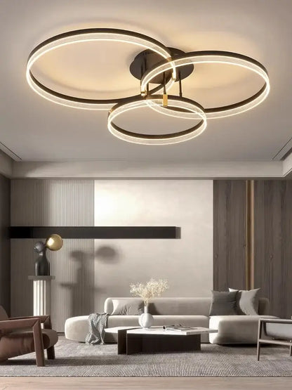 Decorbites acrylic ceiling chandelier with three interlocking black and gold rings for modern living room lighting
