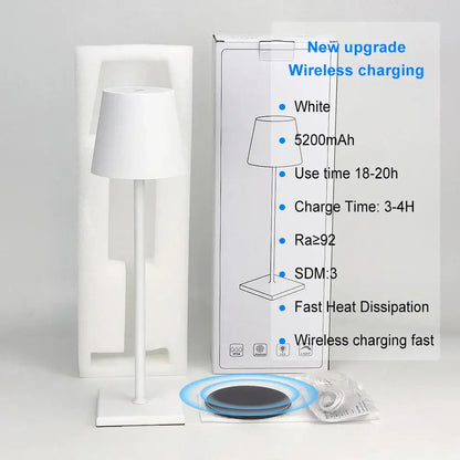 White minimalist DecorBites™ acrylic crystal art LED table lamp with sleek modern design and wireless charging pad nearby