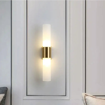 Gold-toned decorbites acrylic cylinder wall lamp with frosted glass and minimalist design for bedroom and living room lighting