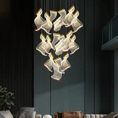 Modern gold-accented acrylic deluxe staircase chandelier with translucent flowing shades for villa lobby lighting