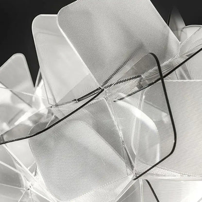 Transparent acrylic chair with geometric layered design and black accents paired with decorbites acrylic flower led table lamp
