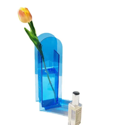 DecorBites acrylic flower vase in translucent blue with modern arch design holding single yellow-orange tulip for home office