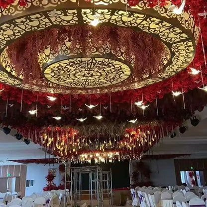 Ornate circular acrylic flying birds led lamp with warm lights and red floral garlands for wedding party décor