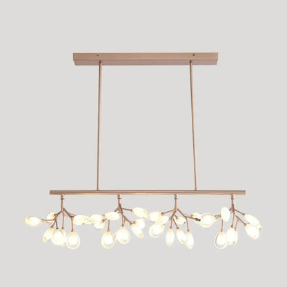 Modern rose gold acrylic island lighting fixture with delicate branch-like arms and teardrop glass bulbs for dining rooms
