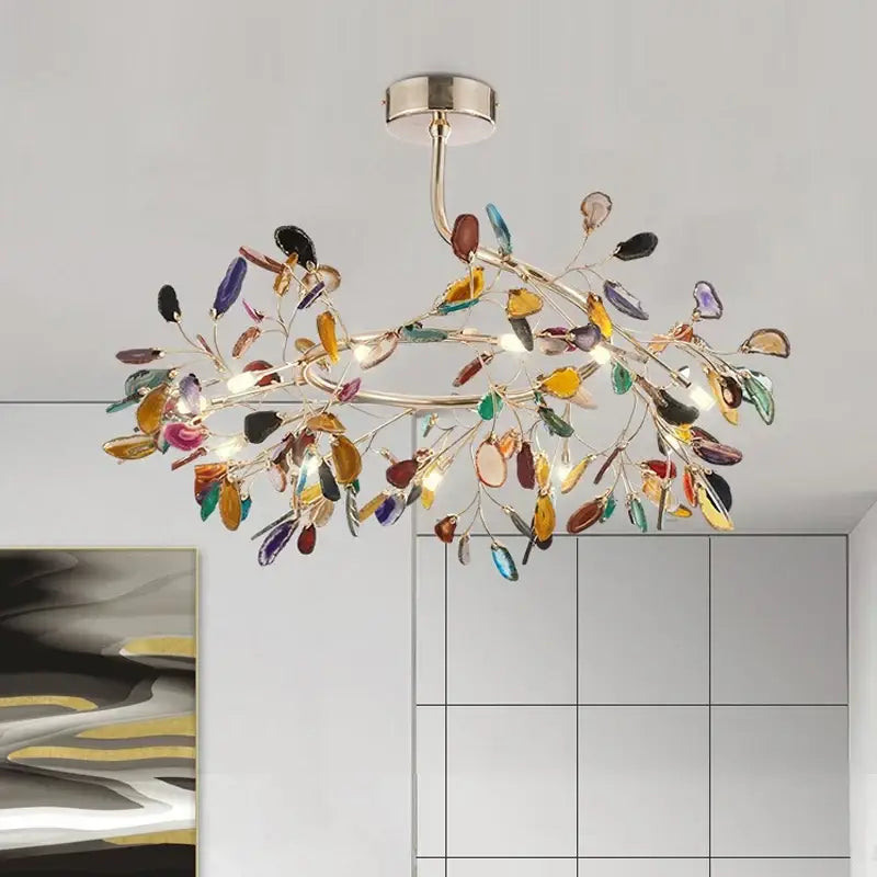 A modern decorbites agate branch chandelier with brass finish and colorful leaf-shaped glass for dining room lighting