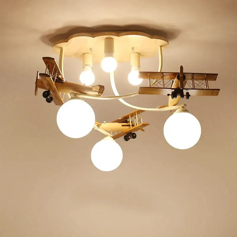 Decorbites wooden airplane chandelier light with three spherical bulbs and cloud-shaped base for nursery room ceiling