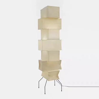 Cream-colored akari noguchi floor lamp with stacked cube rice paper shade and thin black metal legs for living room decor