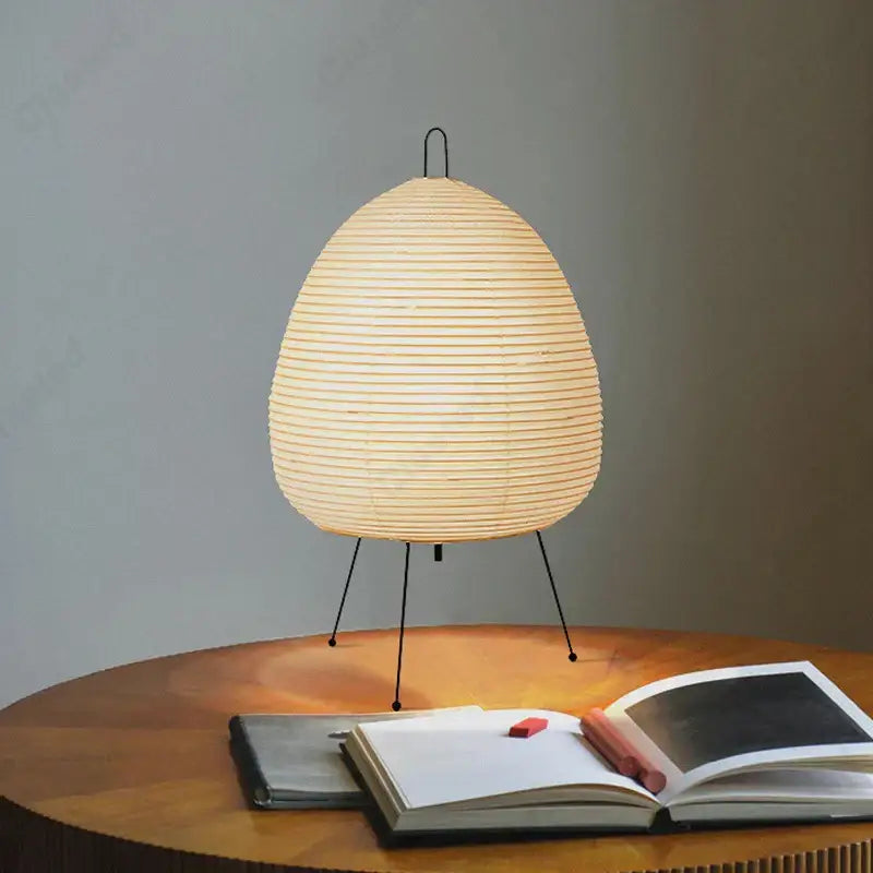 DecorBites™ akari noguchi table lamp with warm-toned egg-shaped rice paper shade and black metal tripod base