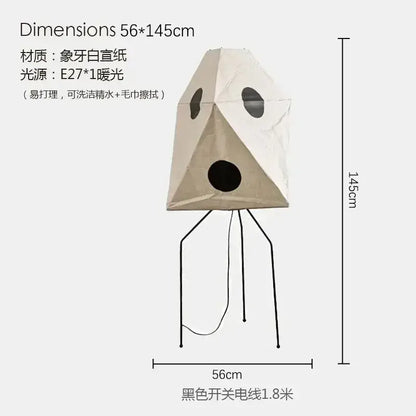 Beige rice paper akari noguchi table lamp with black circular cutouts and tripod base for versatile lighting